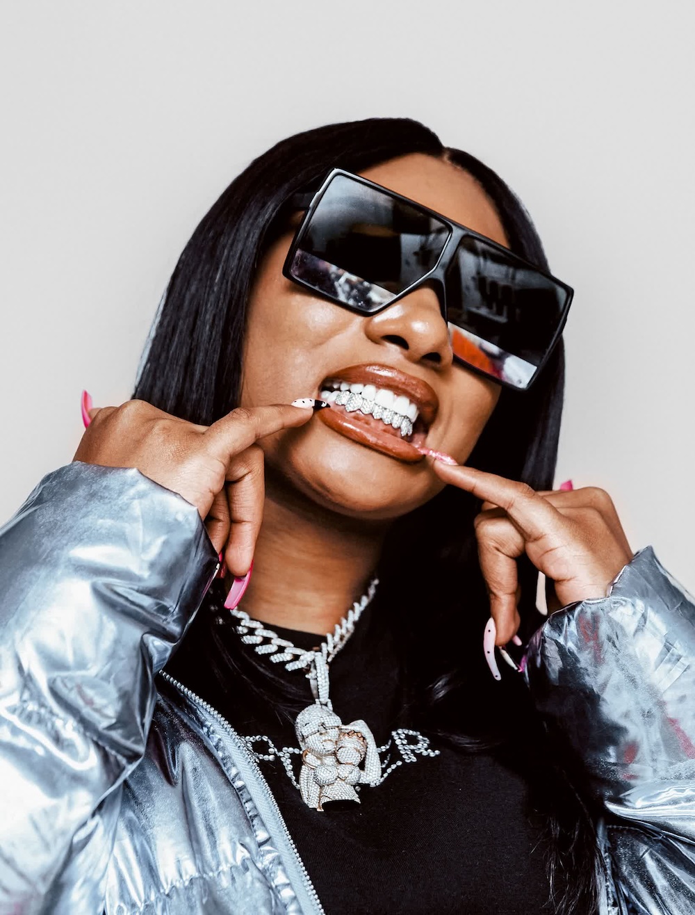 Megan Thee Stallion shows off her diamond grill with a matching pendant. (Zach Boisjoly)